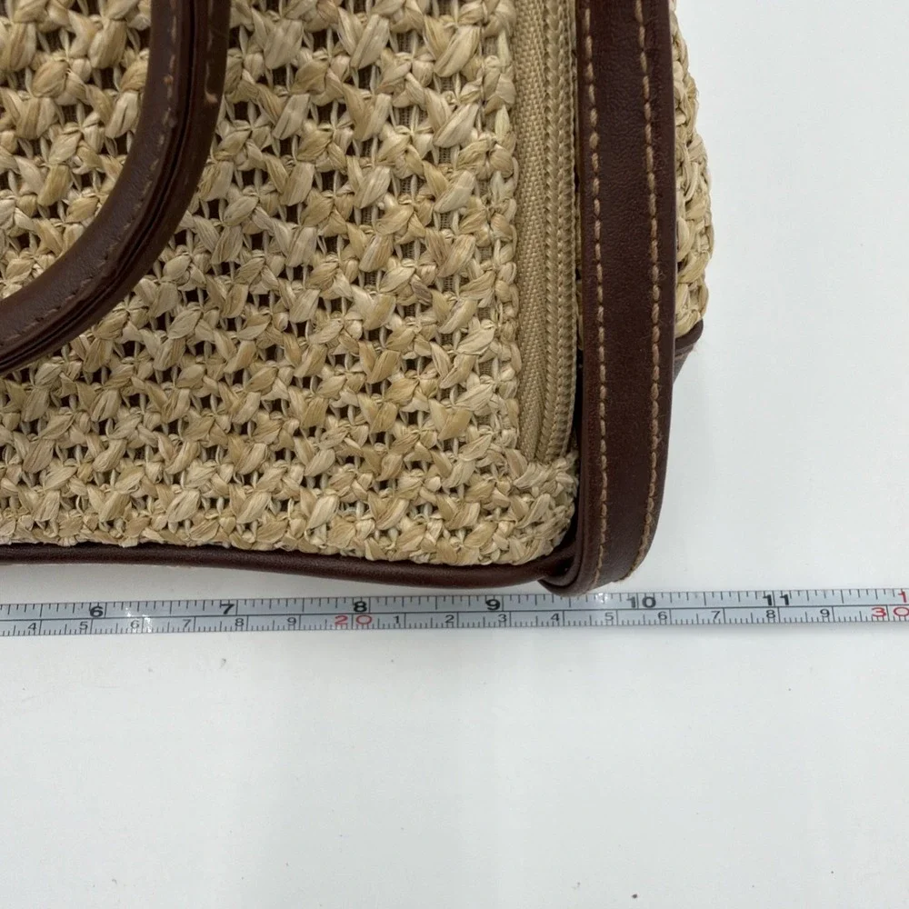 Rosetti straw tote handbag with brown faux leather trim‎ and top handles.